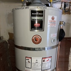 Image of a water heater installed by DiscoverPlumbing&Rooter, showcasing the brand logo and installation details in a San Francisco home.